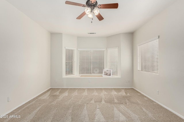 empty room with light colored carpet and ceiling fan