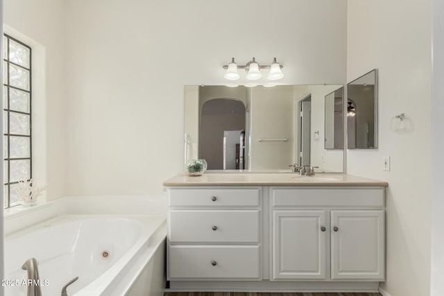 bathroom with vanity and a tub