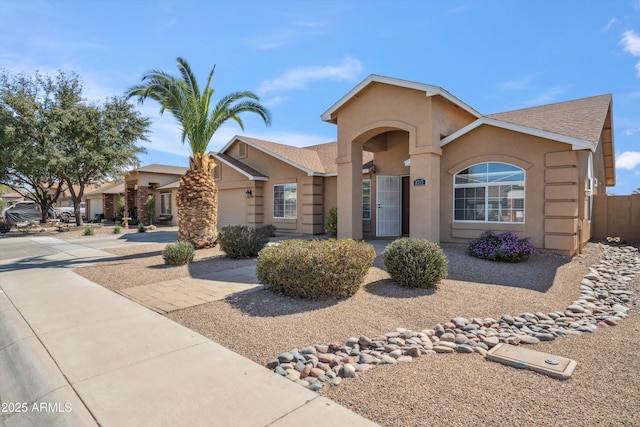 view of front of home with a garage, roof with shingles, driveway, and stucco siding