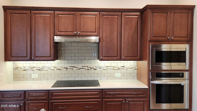 kitchen with appliances with stainless steel finishes and tasteful backsplash