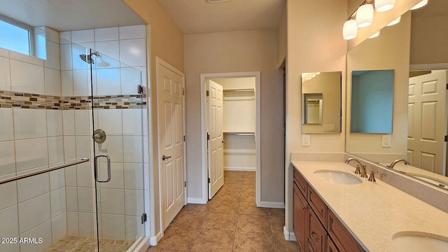 bathroom featuring vanity, tile patterned floors, and walk in shower