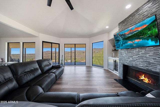15261 E Golden Eagle Blvd, Fountain Hills, AZ 85268 - living area with a fireplace, dark wood-style flooring, plenty of natural light, recessed lighting, and wine cooler