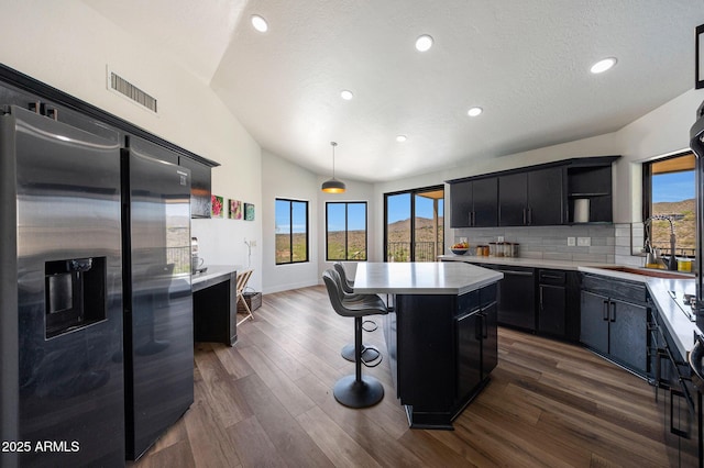 15261 E Golden Eagle Blvd, Fountain Hills, AZ 85268 - kitchen with stainless steel fridge, open shelves, dark cabinetry, dishwashing machine, and lofted ceiling