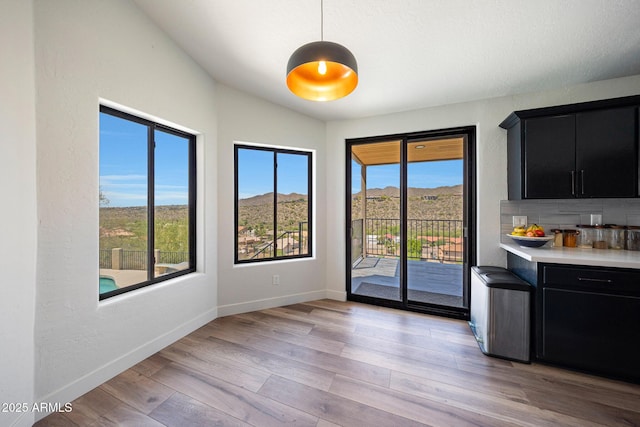 15261 E Golden Eagle Blvd, Fountain Hills, AZ 85268 - unfurnished dining area with healthy amount of natural light, light wood-type flooring, and bar