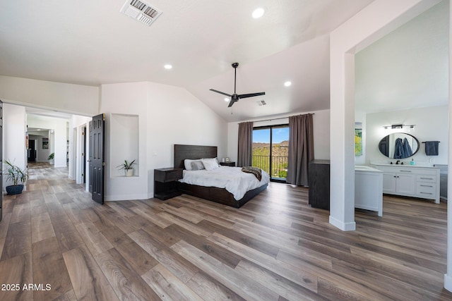 15261 E Golden Eagle Blvd, Fountain Hills, AZ 85268 - bedroom with vaulted ceiling, wood finished floors, access to outside, recessed lighting, and connected bathroom