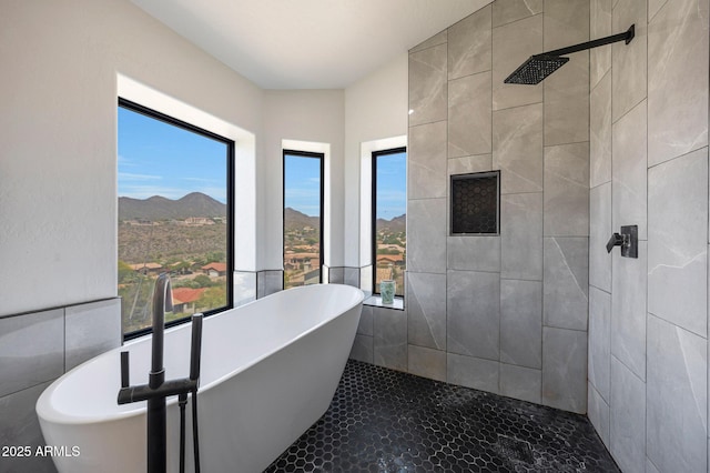 15261 E Golden Eagle Blvd, Fountain Hills, AZ 85268 - bathroom with a freestanding bath, tiled shower, tile walls, and a mountain view