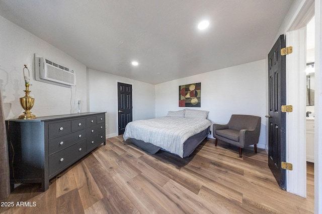 15261 E Golden Eagle Blvd, Fountain Hills, AZ 85268 - bedroom featuring a wall mounted air conditioner, wood finished floors, and recessed lighting