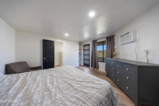 15261 E Golden Eagle Blvd, Fountain Hills, AZ 85268 - bedroom featuring a wall mounted air conditioner, wood finished floors, and recessed lighting