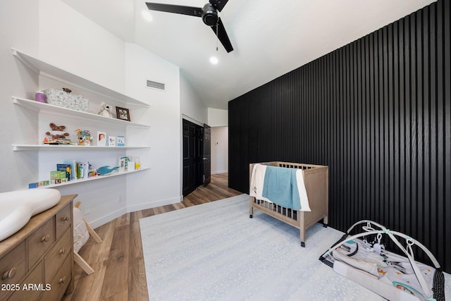 15261 E Golden Eagle Blvd, Fountain Hills, AZ 85268 - bedroom with light wood-type flooring, an accent wall, a ceiling fan, and high vaulted ceiling