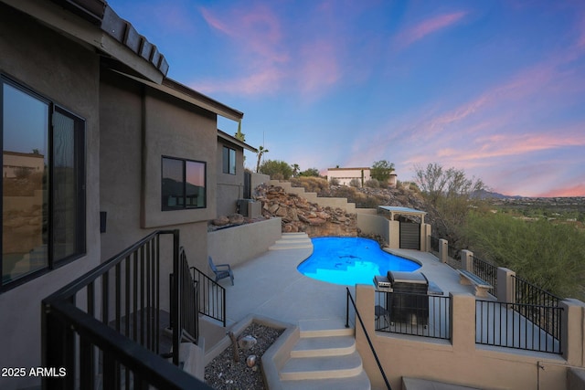 15261 E Golden Eagle Blvd, Fountain Hills, AZ 85268 - pool at dusk featuring a patio and stairs