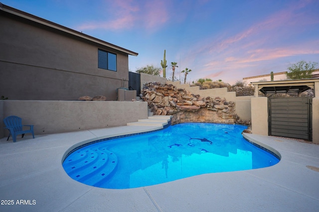 15261 E Golden Eagle Blvd, Fountain Hills, AZ 85268 - pool at dusk featuring a patio area