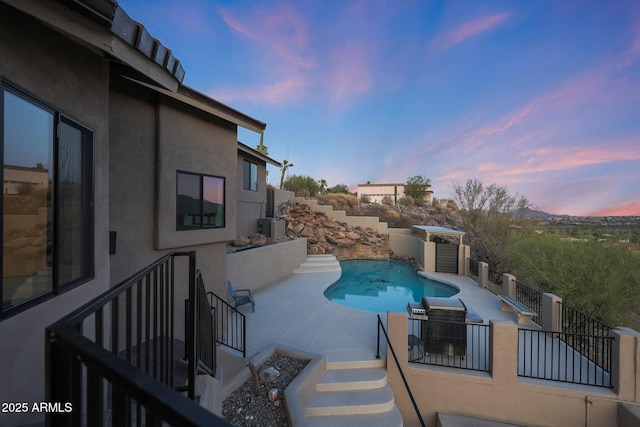 15261 E Golden Eagle Blvd, Fountain Hills, AZ 85268 - pool at dusk featuring a patio area and stairway