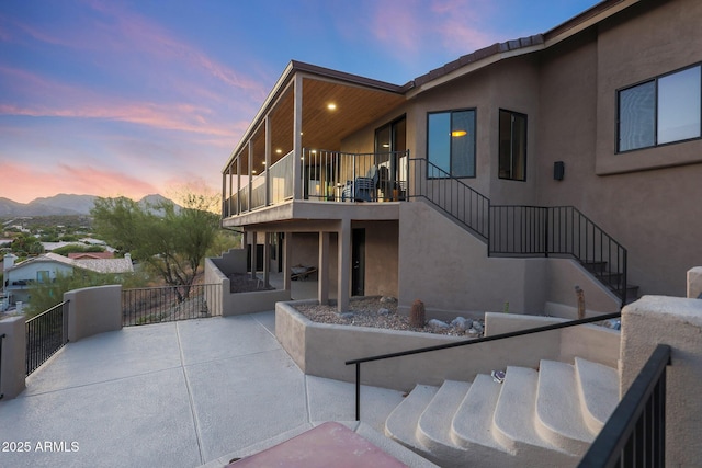 15261 E Golden Eagle Blvd, Fountain Hills, AZ 85268 - back of property with stairs, stucco siding, a balcony, a patio area, and a mountain view