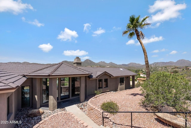 15261 E Golden Eagle Blvd, Fountain Hills, AZ 85268 - view of front of home featuring stucco siding, a mountain view, a chimney, and a tile roof
