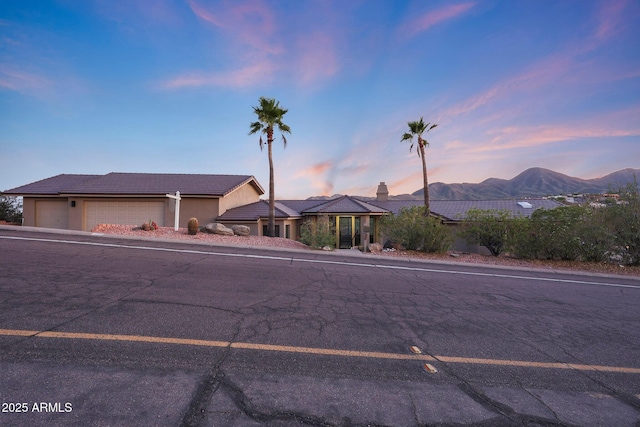 15261 E Golden Eagle Blvd, Fountain Hills, AZ 85268 - single story home with a mountain view, stucco siding, a garage, and a tile roof