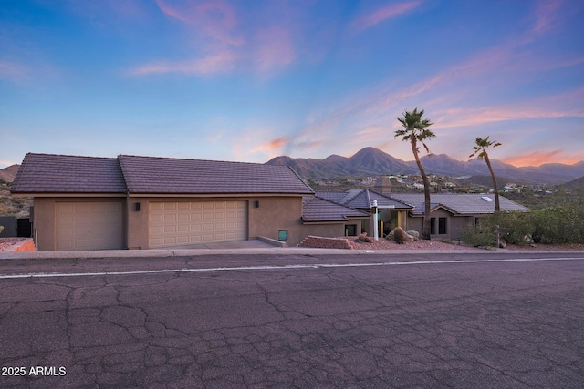 15261 E Golden Eagle Blvd, Fountain Hills, AZ 85268 - view of front facade featuring stucco siding, a mountain view, a tile roof, and a garage