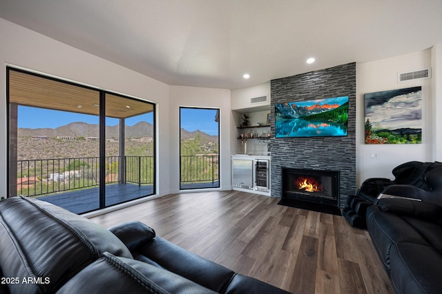 15261 E Golden Eagle Blvd, Fountain Hills, AZ 85268 - living room with beverage cooler, wood finished floors, a fireplace, and recessed lighting