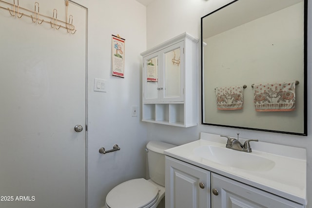 bathroom with toilet and vanity