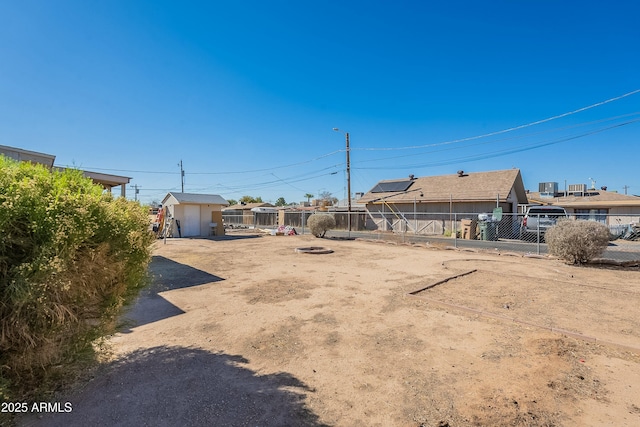 view of yard with an outbuilding and fence