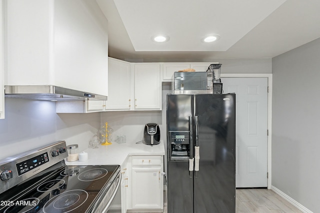 kitchen with light wood-style floors, white cabinetry, appliances with stainless steel finishes, and light countertops