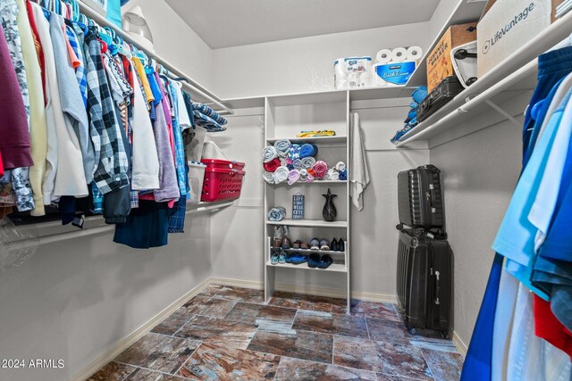 1216 Easy St, Wickenburg, AZ 85390 - walk in closet featuring stone finish flooring
