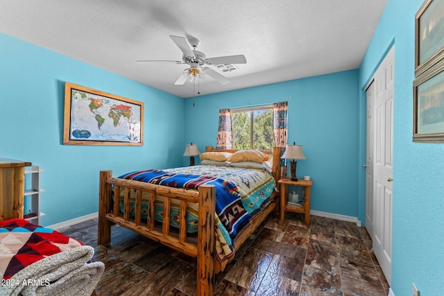 1216 Easy St, Wickenburg, AZ 85390 - bedroom with baseboards, a textured ceiling, a closet, and ceiling fan