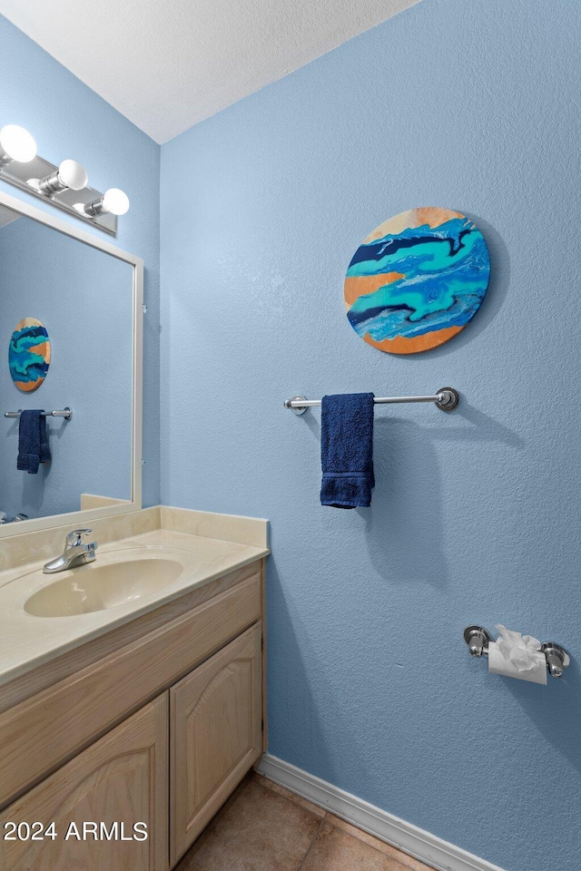 bathroom with tile patterned floors, vanity, and a textured ceiling