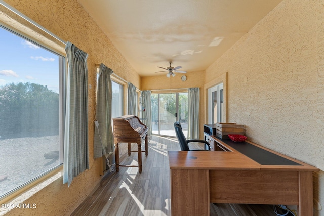 sunroom featuring ceiling fan and a wealth of natural light