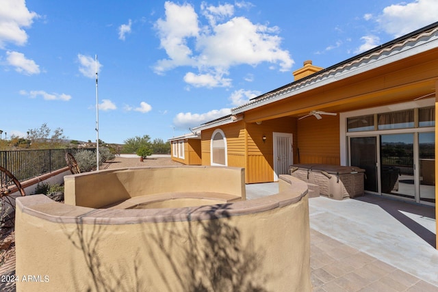 view of patio / terrace featuring a hot tub and ceiling fan