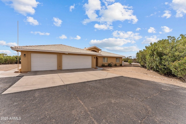 1216 Easy St, Wickenburg, AZ 85390 - single story home with driveway, stucco siding, an attached garage, and a tiled roof