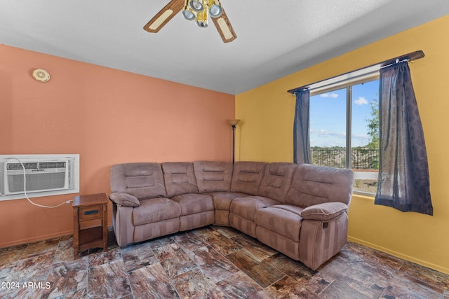 living room with ceiling fan and a wall unit AC