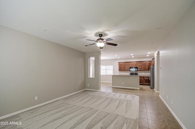 unfurnished living room featuring light tile patterned floors, ceiling fan, recessed lighting, and baseboards