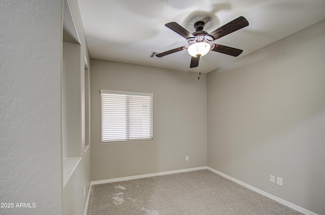 unfurnished room with carpet floors, visible vents, baseboards, and a ceiling fan