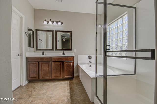 bathroom with a bath, a sink, visible vents, and a shower stall