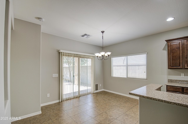 unfurnished dining area with a chandelier, light tile patterned floors, visible vents, and baseboards