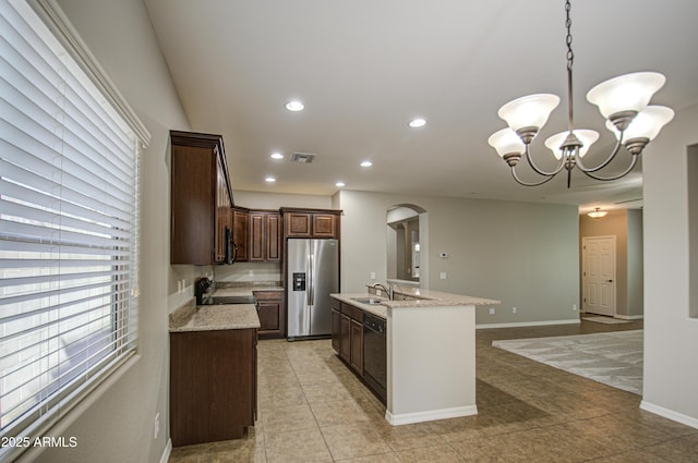 kitchen with stainless steel fridge, visible vents, electric stove, a kitchen island with sink, and dark brown cabinets