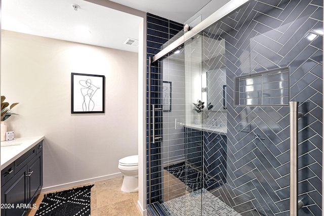 bathroom with visible vents, baseboards, toilet, a stall shower, and vanity