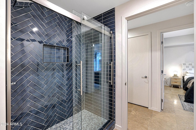 ensuite bathroom with connected bathroom, a stall shower, and tile patterned flooring