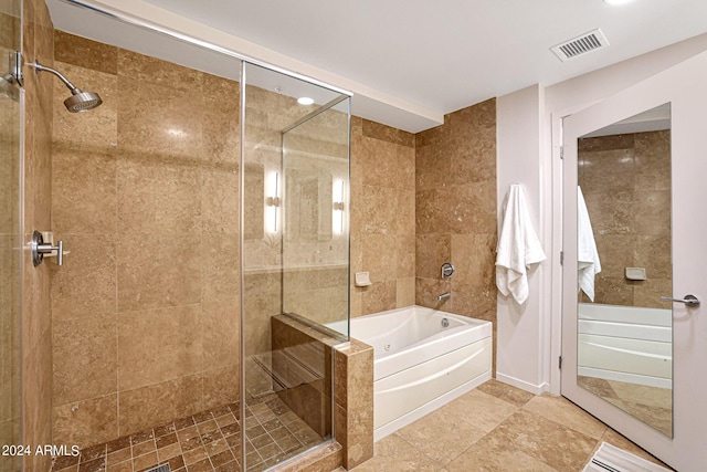 full bathroom featuring a garden tub, visible vents, and a stall shower