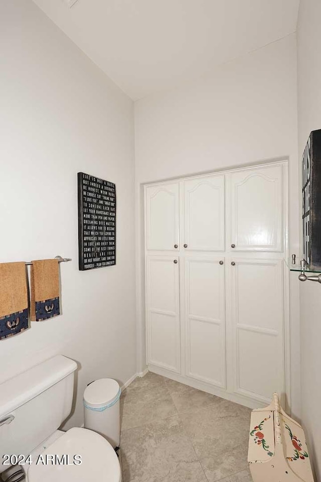 bathroom with toilet and baseboards