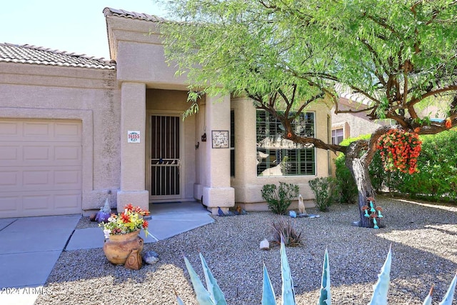 view of exterior entry with a garage