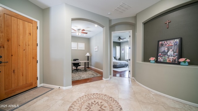 entryway featuring visible vents, arched walkways, a healthy amount of sunlight, and light tile patterned flooring