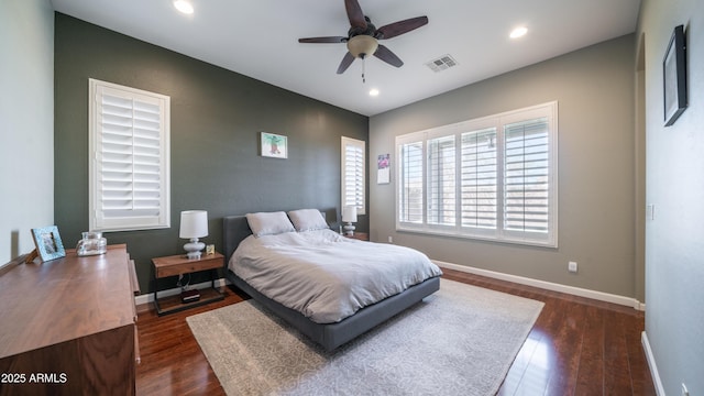 bedroom with recessed lighting, dark wood-style floors, visible vents, and baseboards