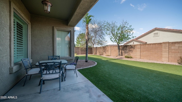 view of yard featuring outdoor dining area, a fenced backyard, and a patio area