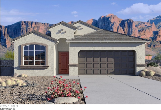 5012 S 106th Ln, Tolleson, AZ 85353 - view of front of house with a mountain view, an attached garage, and driveway