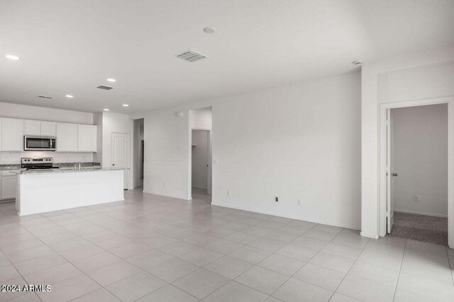 5012 S 106th Ln, Tolleson, AZ 85353 - unfurnished living room with recessed lighting and visible vents