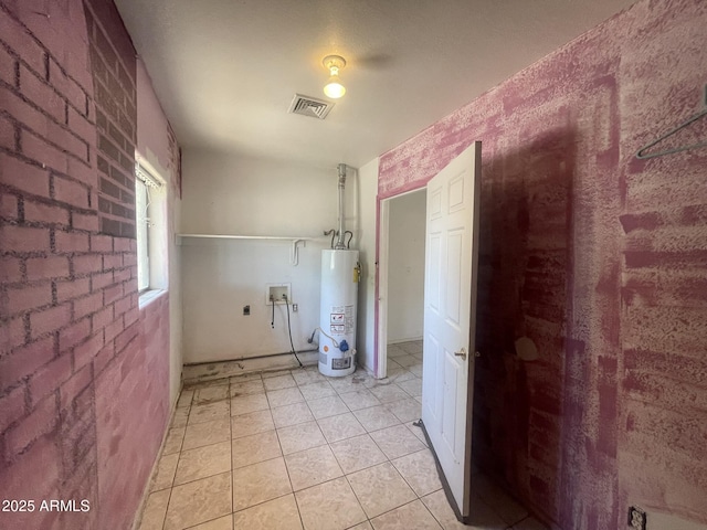 403 E 6th St, Douglas, AZ 85607 - laundry room featuring gas water heater, washer hookup, hookup for an electric dryer, brick wall, and light tile patterned flooring