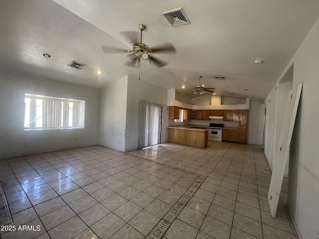 403 E 6th St, Douglas, AZ 85607 - unfurnished living room with a ceiling fan, lofted ceiling, and light tile patterned flooring