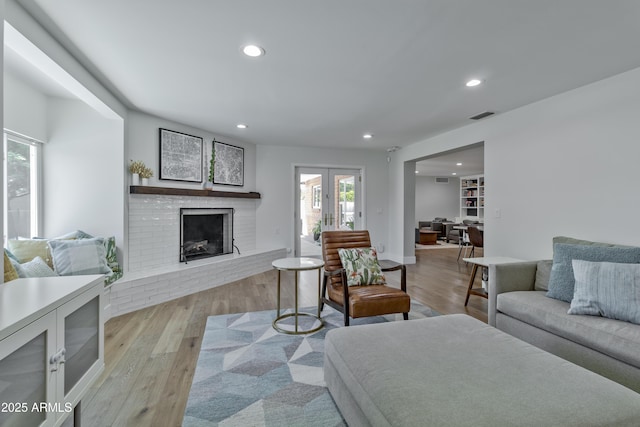 1839 E Palo Verde Dr, Phoenix, AZ 85016 - living room with recessed lighting, a brick fireplace, and light wood-style floors