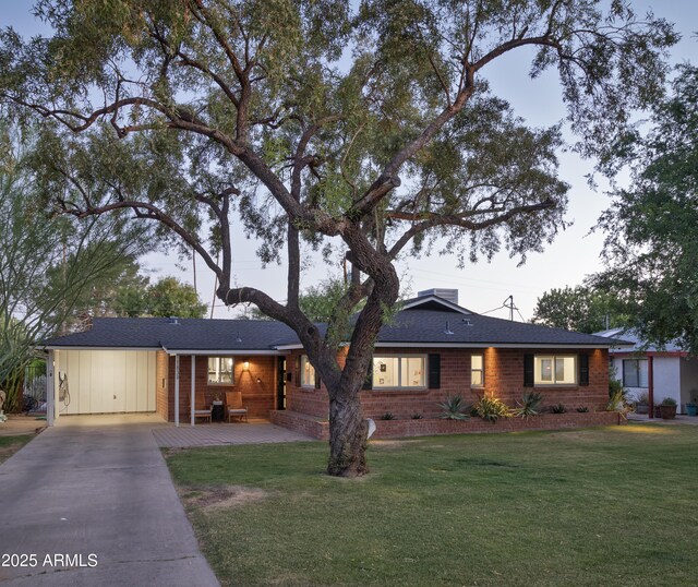 1839 E Palo Verde Dr, Phoenix, AZ 85016 - ranch-style home with driveway, an attached carport, brick siding, and a front lawn